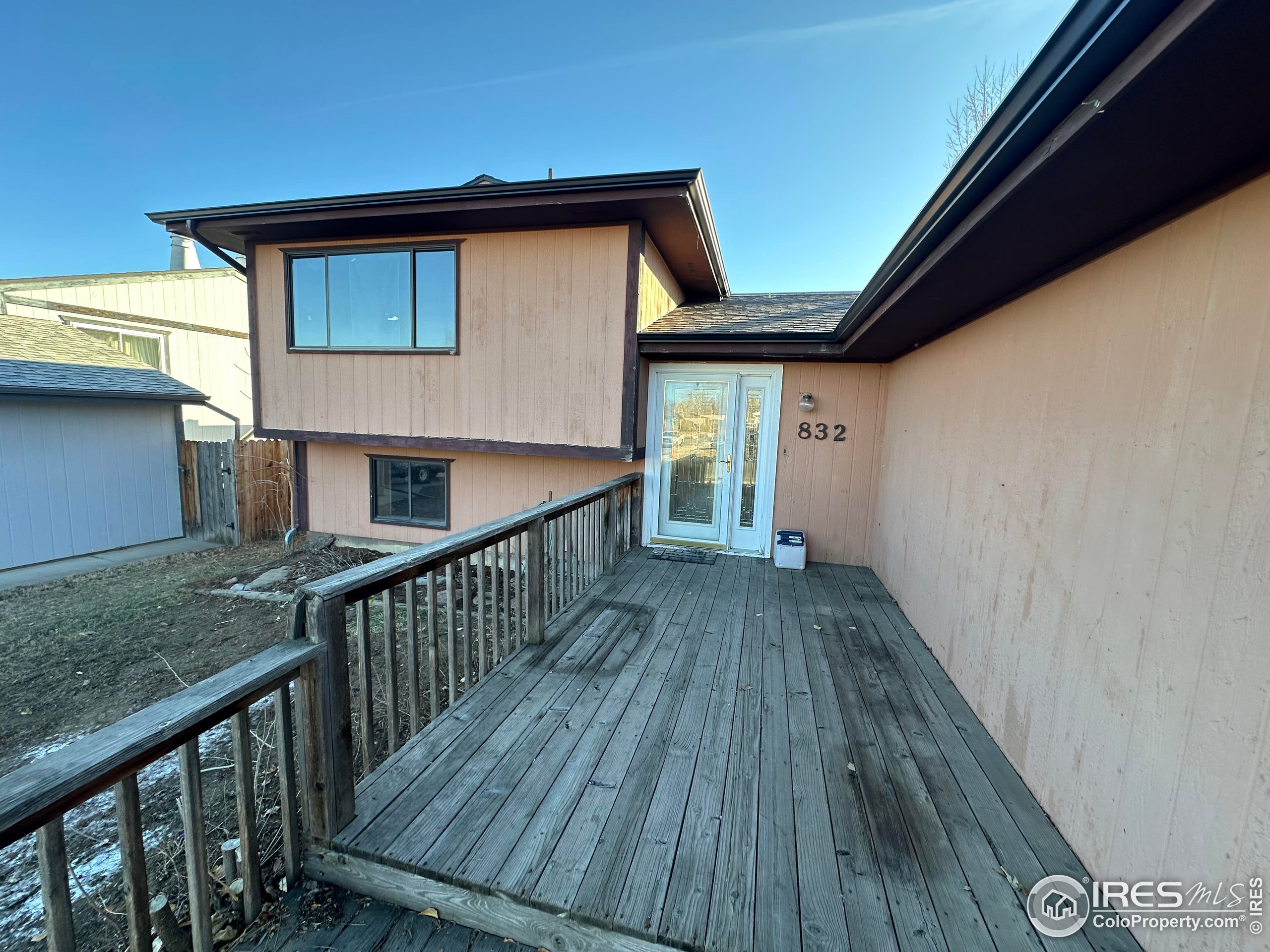 832 21st Street Southwest Loveland, CO 80537 - Photo 3 of 15 a view of backyard of house with wooden floor