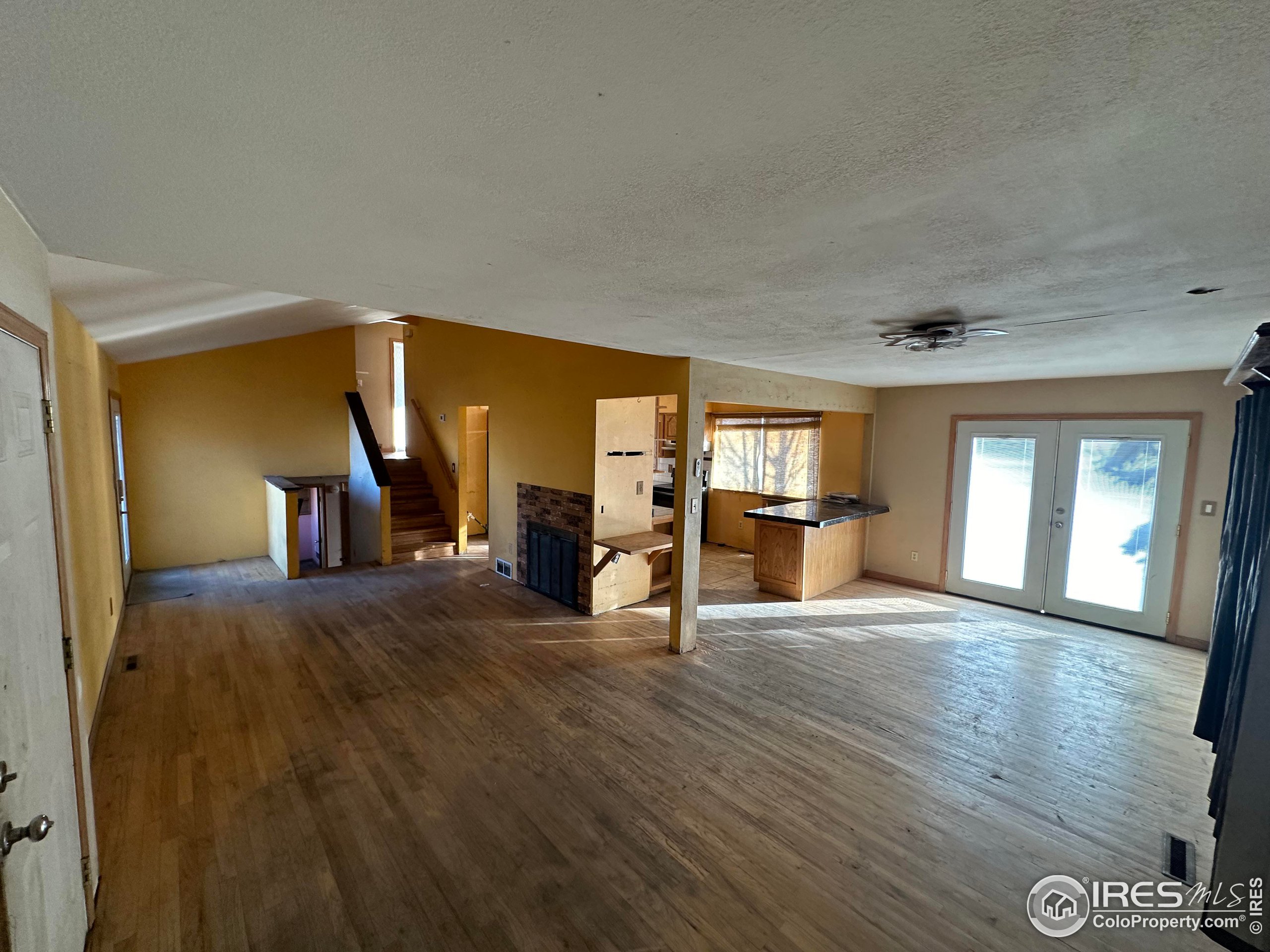832 21st Street Southwest Loveland, CO 80537 - Photo 5 of 15 a view of a livingroom with wooden floor and a fireplace