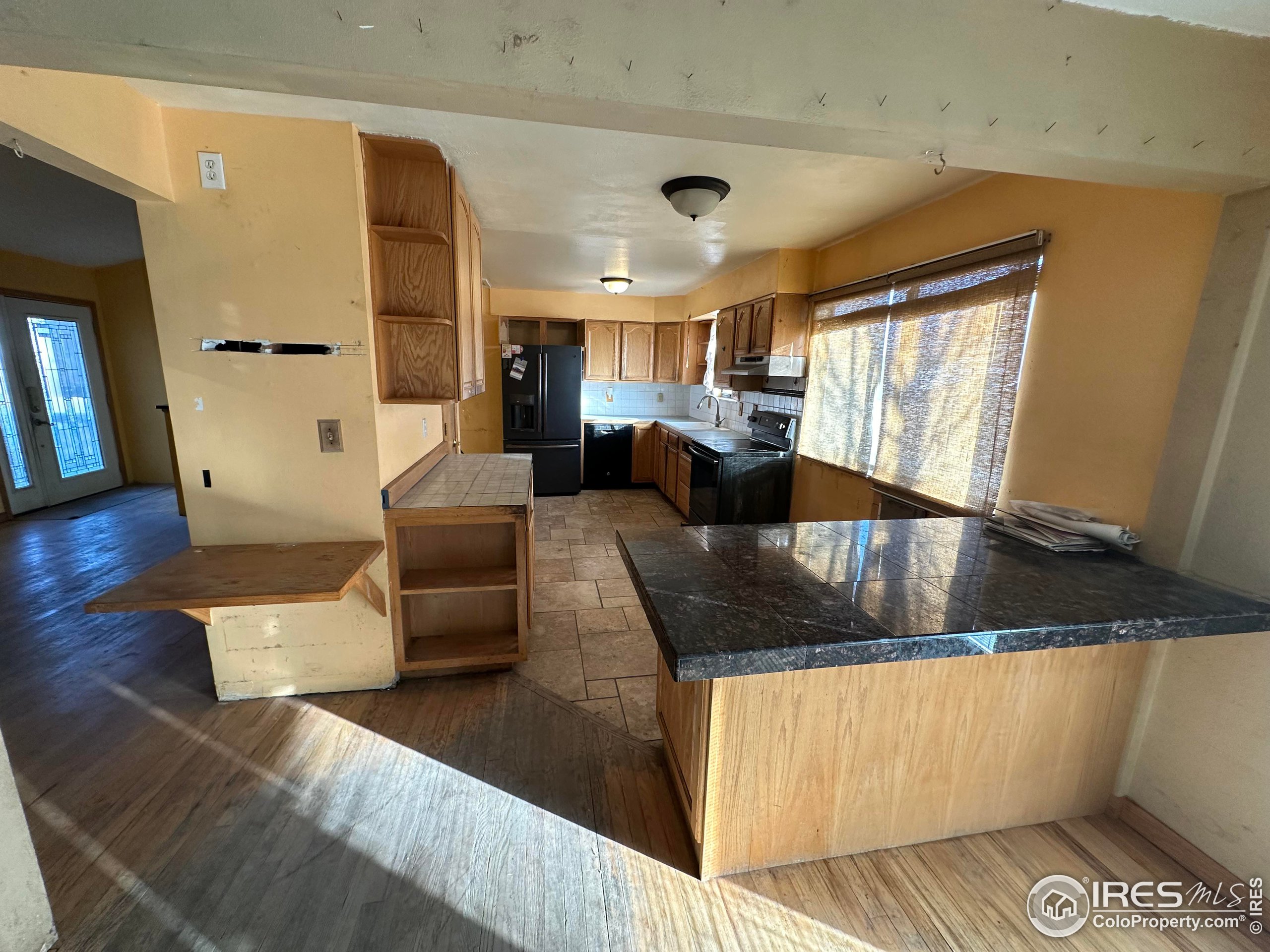 832 21st Street Southwest Loveland, CO 80537 - Photo 7 of 15 a living room with furniture and wooden floor