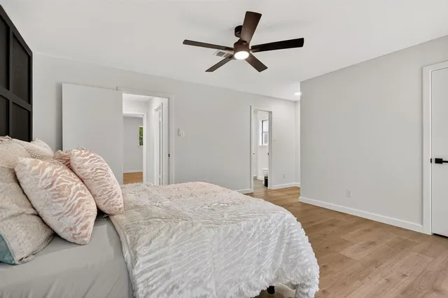 a bedroom with a bed and a ceiling fan