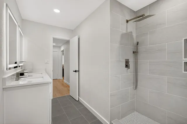 a bathroom with a bathtub sink vanity and a mirror