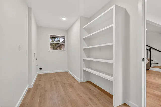a view of room with wooden floor and window