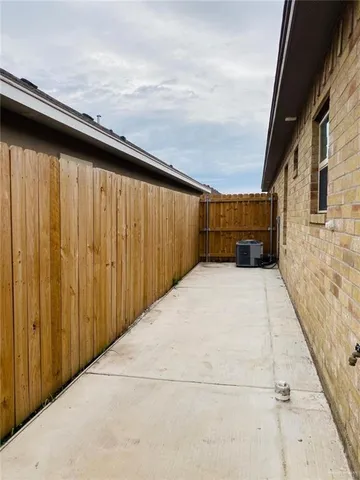 a view of balcony with wooden floor and fence