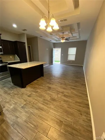 a bathroom with a granite countertop sink toilet and mirror