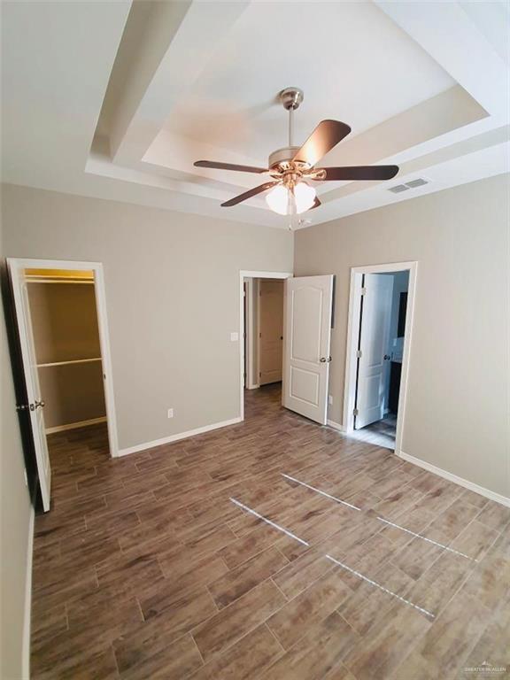 2000 Jackson Street, Unit 1 Weslaco, TX 78599 - Photo 8 of 10 a view of a big room with wooden floor and chandelier fan