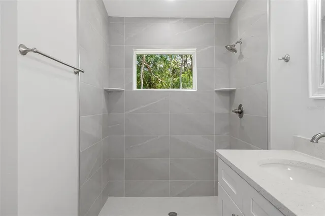 a bathroom with double sink a toilet and a mirror