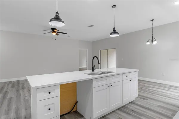 a kitchen with a sink a stove and cabinets