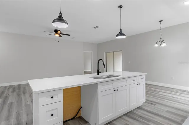 a kitchen with a sink a stove and cabinets