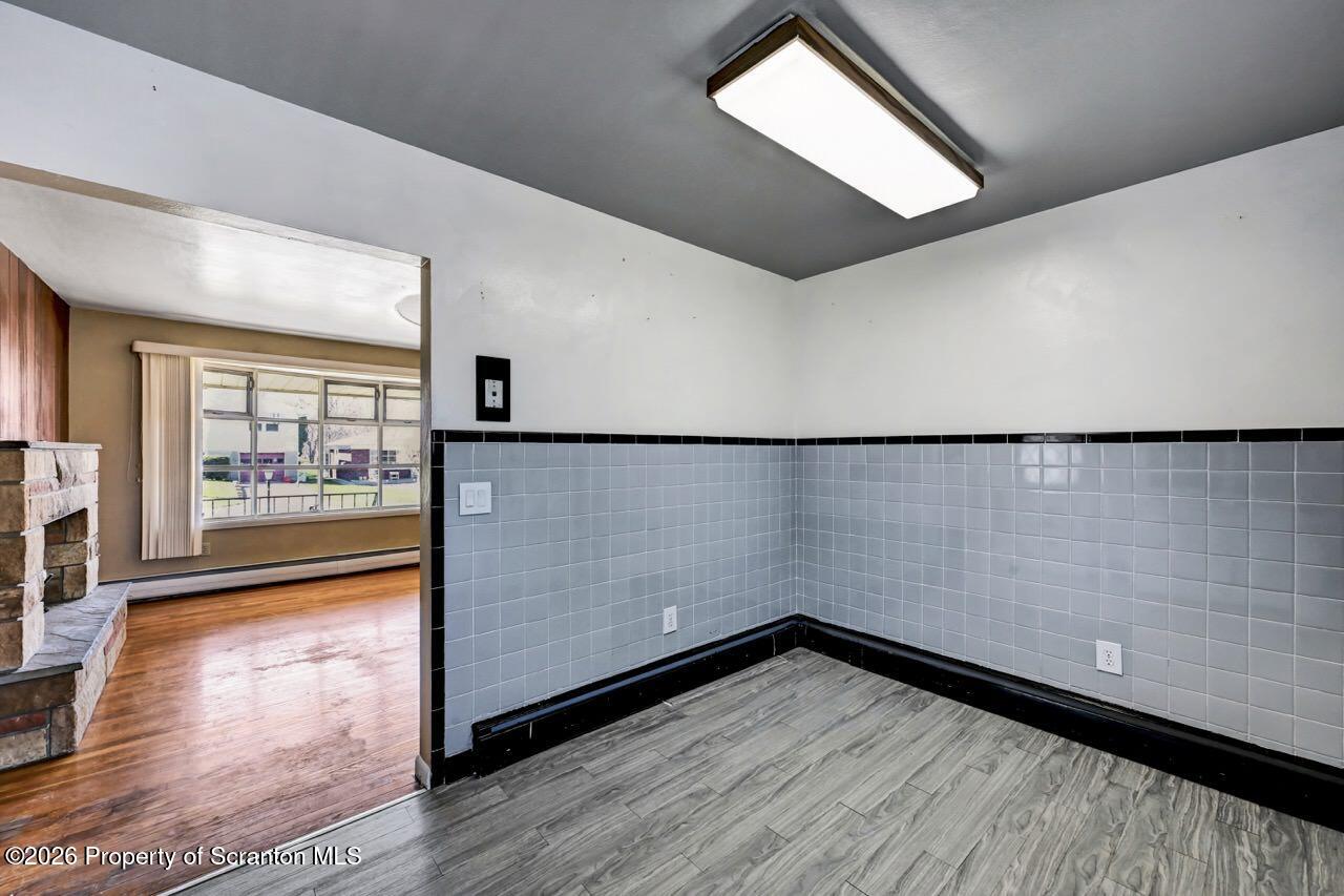 703 Ohara Street Scranton, PA 18505 - Photo 14 of 36 wooden floor in an empty room with a window