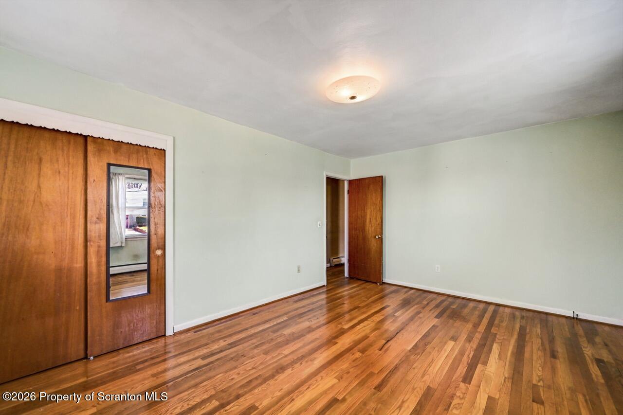 703 Ohara Street Scranton, PA 18505 - Photo 18 of 36 a view of an empty room and wooden floor