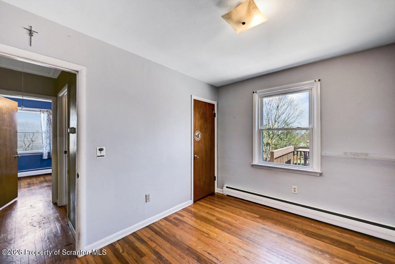 703 Ohara Street Scranton, PA 18505 - Photo 20 of 36 a view of an empty room with wooden floor and a window