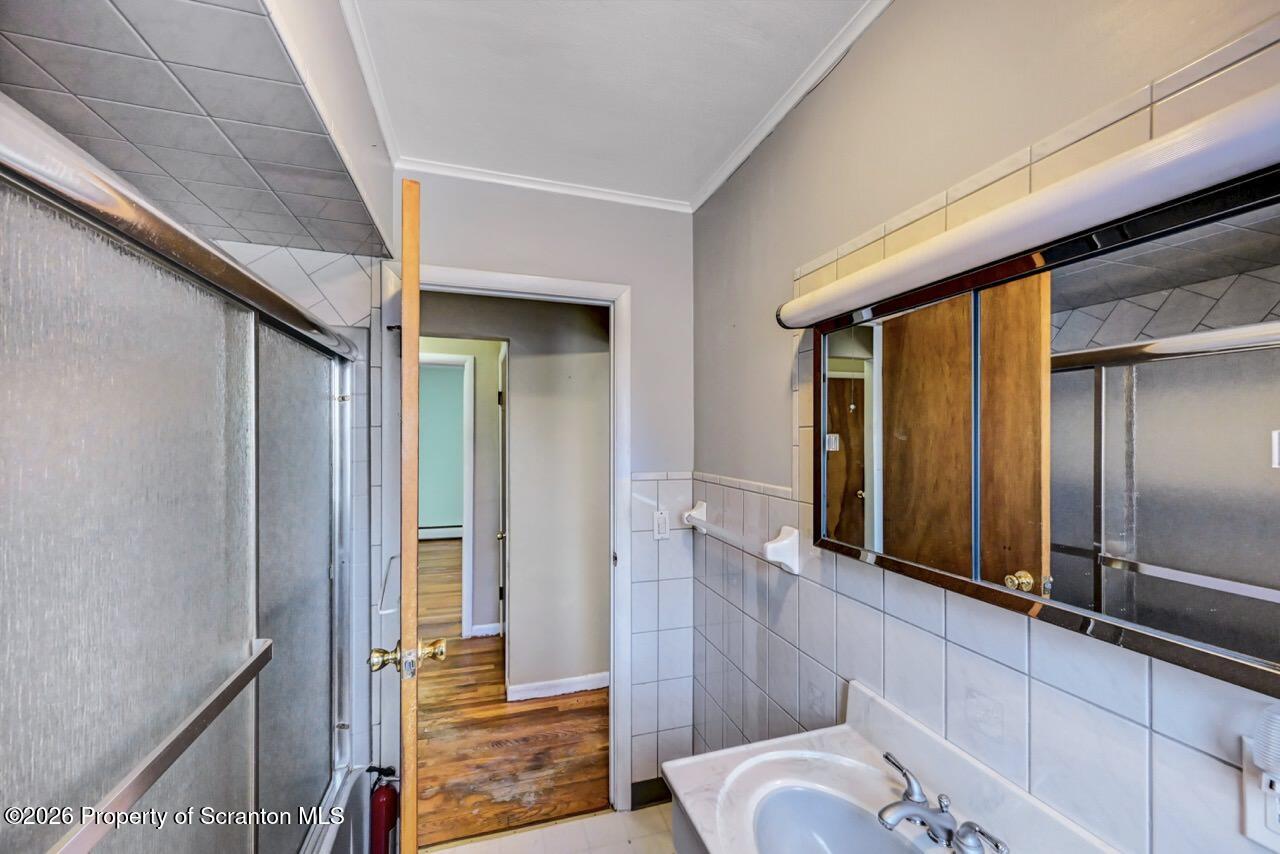 703 Ohara Street Scranton, PA 18505 - Photo 23 of 36 a bathroom with a tub and shower