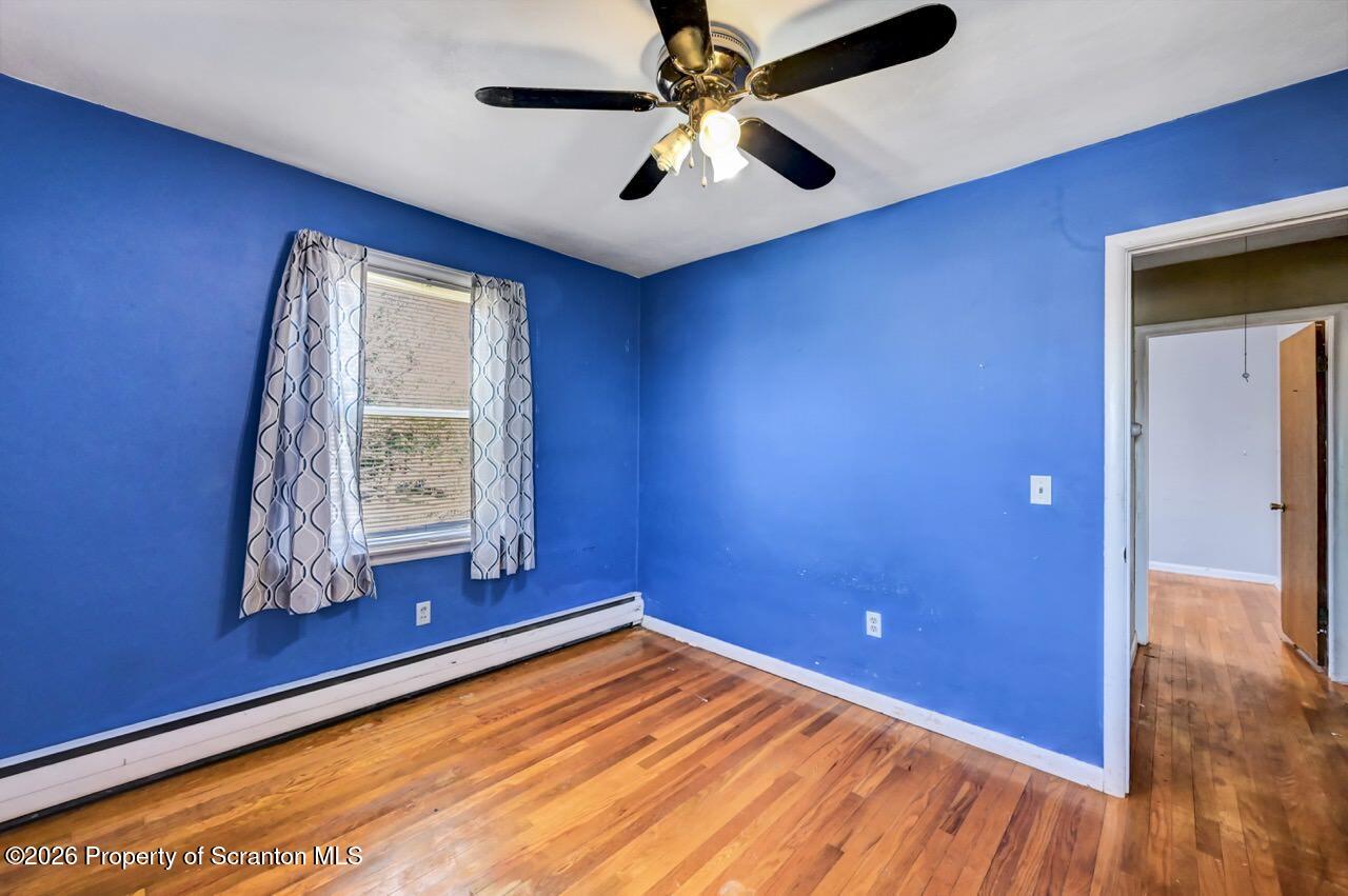 703 Ohara Street Scranton, PA 18505 - Photo 26 of 36 a view of empty room with wooden floor and fan