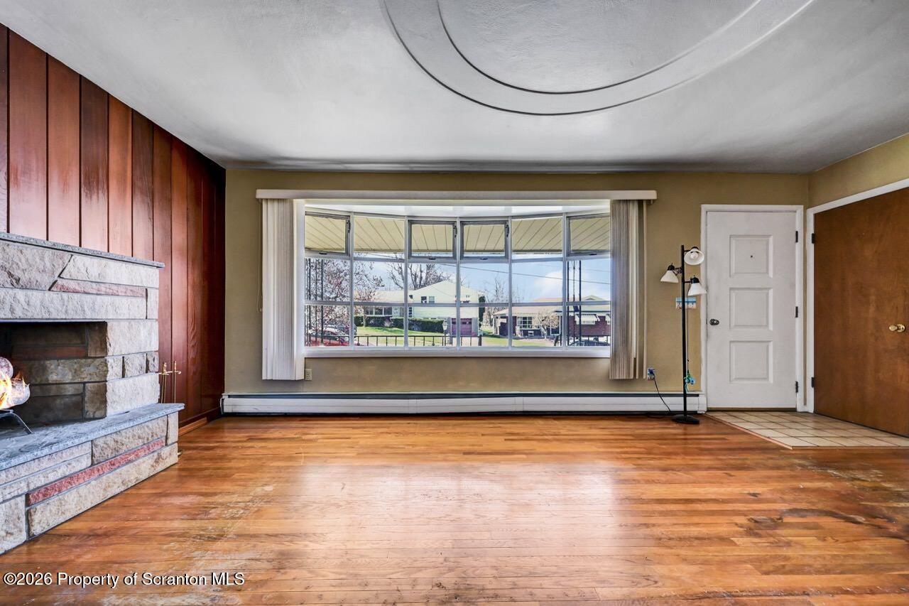 703 Ohara Street Scranton, PA 18505 - Photo 6 of 36 an empty room with floor to ceiling windows and fireplace