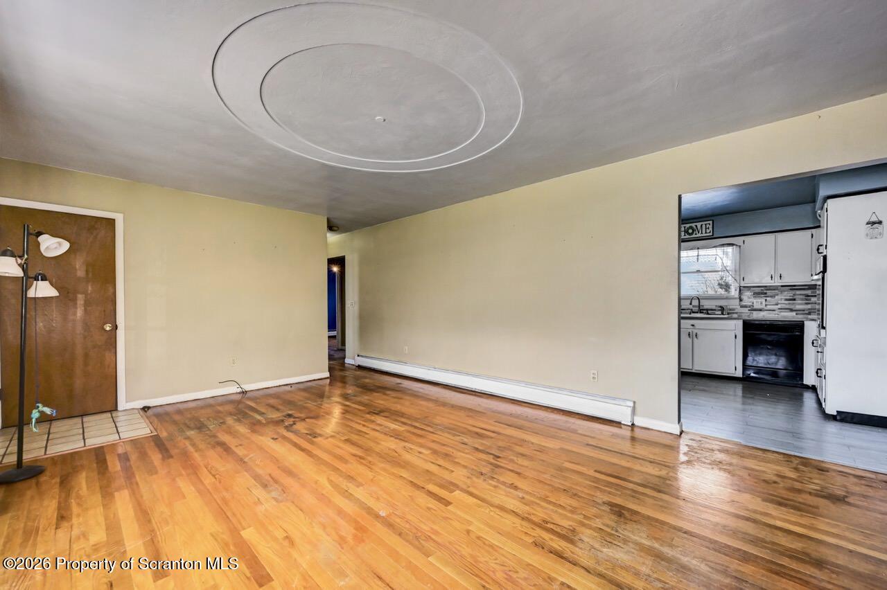 703 Ohara Street Scranton, PA 18505 - Photo 8 of 36 a view of empty room with a sink and wooden floor