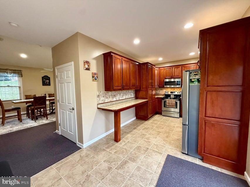 911 Lower Main Street Saxton, PA 16678 - Photo 24 of 63 a kitchen with stainless steel appliances granite countertop a refrigerator and a stove top oven