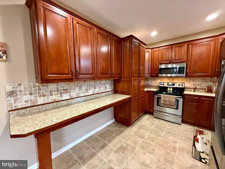 911 Lower Main Street Saxton, PA 16678 - Photo 26 of 63 a kitchen with stainless steel appliances granite countertop a stove a sink and a microwave
