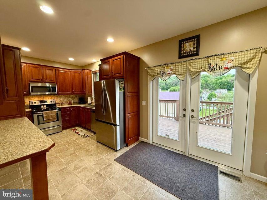 911 Lower Main Street Saxton, PA 16678 - Photo 31 of 63 a kitchen with stainless steel appliances granite countertop a refrigerator and a stove top oven