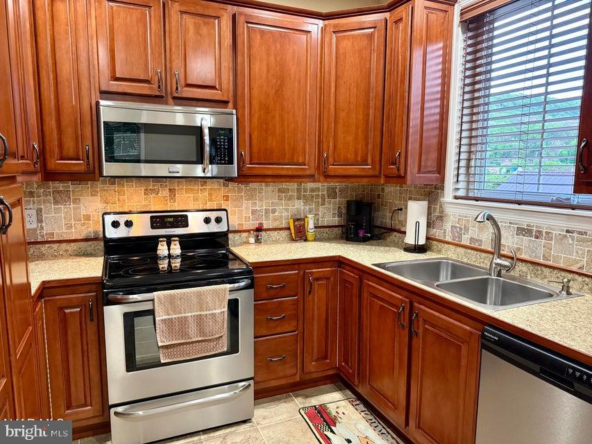 911 Lower Main Street Saxton, PA 16678 - Photo 4 of 63 a kitchen with stainless steel appliances granite countertop a sink stove and microwave