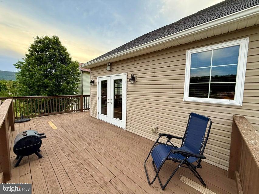 911 Lower Main Street Saxton, PA 16678 - Photo 50 of 63 a view of deck with table and chairs and wooden floor