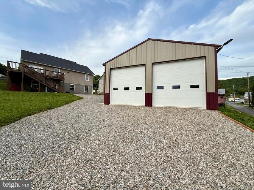 911 Lower Main Street Saxton, PA 16678 - Photo 56 of 63 a front view of a house with a yard and garage
