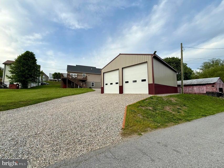 911 Lower Main Street Saxton, PA 16678 - Photo 57 of 63 a view of a house with a yard and a garage