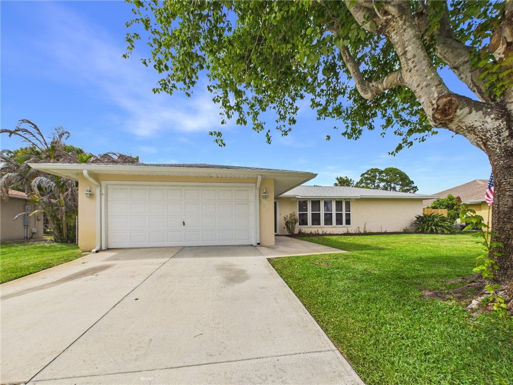 225 Midvale Terrace Sebastian, FL 32958 - Photo 2 of 25 a front view of a house with a garden and yard