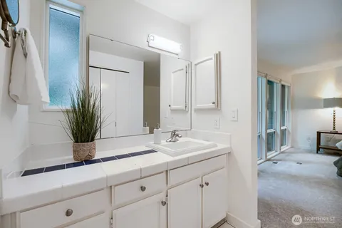 a bathroom with a double vanity sink and a mirror