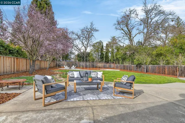 a backyard of a house with table and chairs