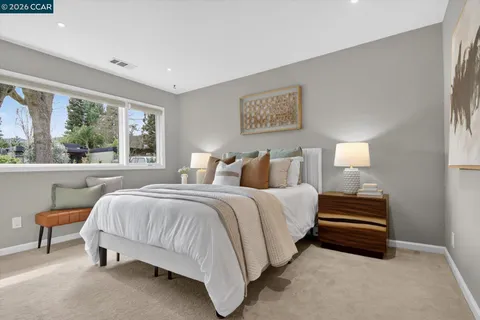 a bedroom with bed and window