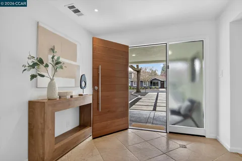 a bathroom with a granite countertop sink a mirror and shower