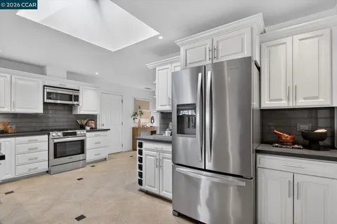 a kitchen with cabinets stainless steel appliances and wooden cabinets