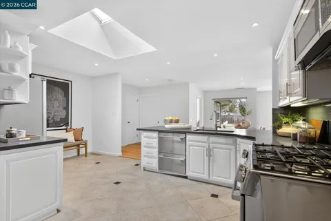 a kitchen with stainless steel appliances a sink stove and cabinets