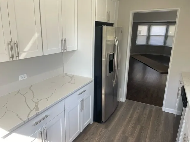 a kitchen with a refrigerator and cabinets