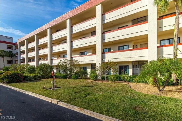 a front view of a building with a garden