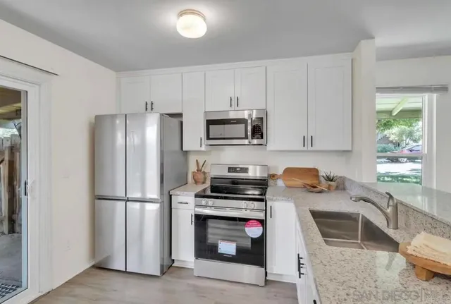a kitchen with a refrigerator stove and microwave