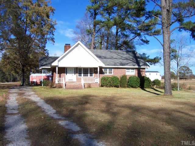 13246 Cleveland Road Garner, NC 27529 - Photo 1 of 1 a front view of house with yard and trees in the background