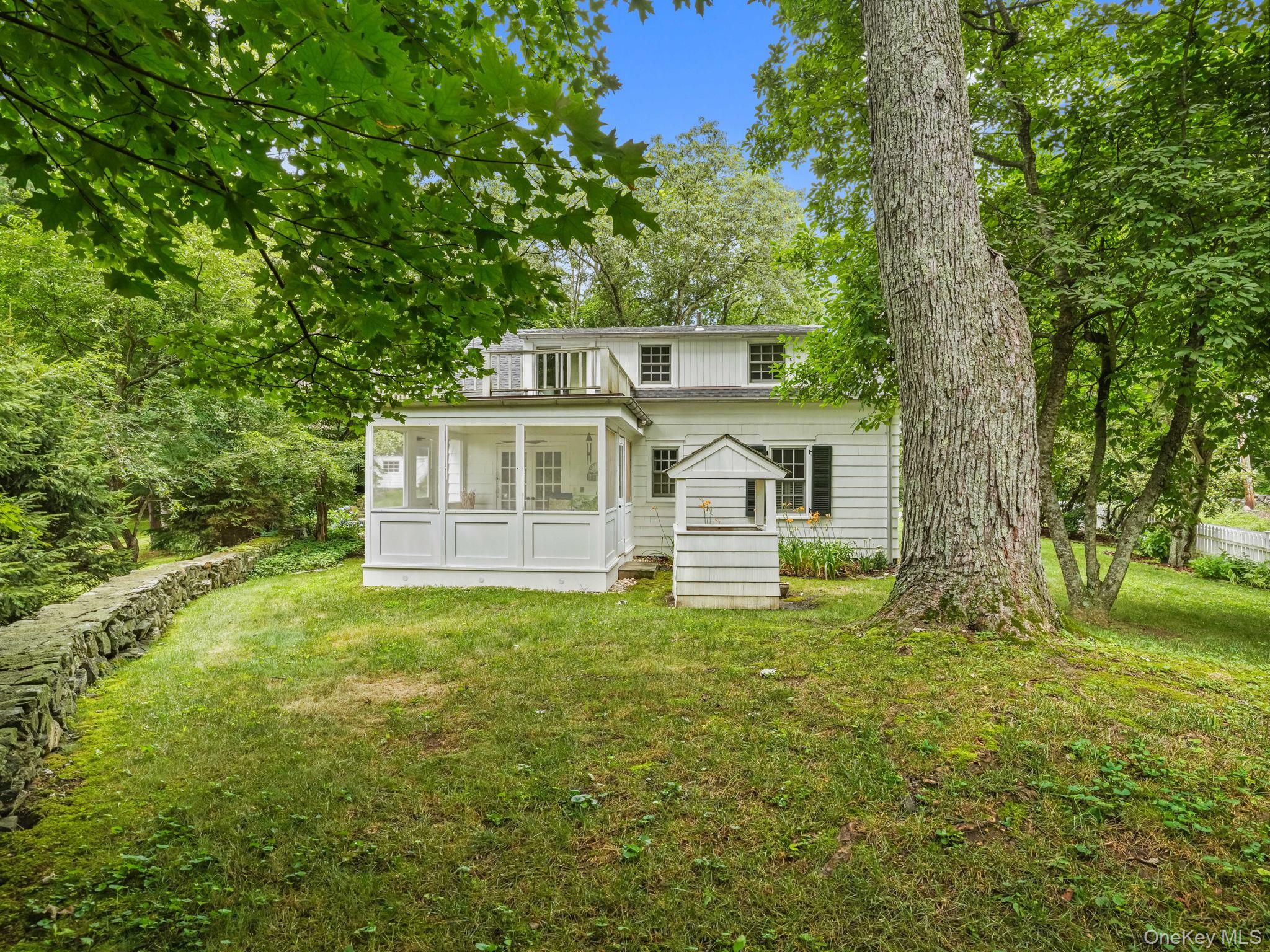 8 South Bedford Road Pound Ridge, NY 10576 - Photo 3 of 32 a front view of a house with a yard
