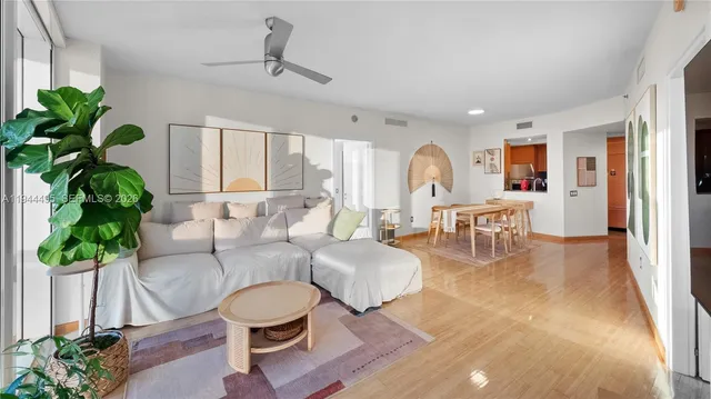 a living room with furniture and a potted plant
