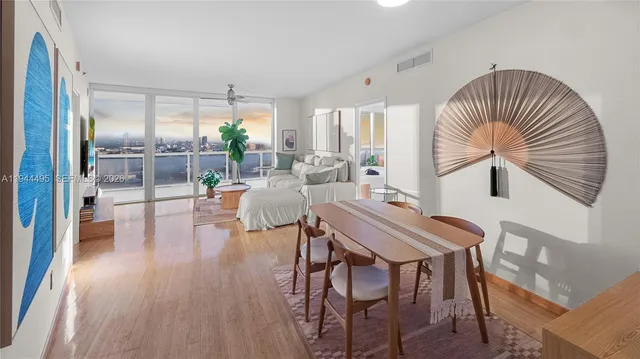 a dining room with furniture and wooden floor