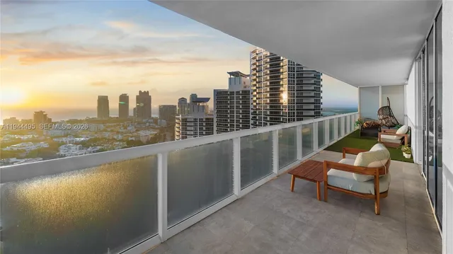 a view of roof deck with two chairs and wooden fence