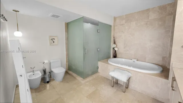 a bathroom with a toilet a sink and a shower