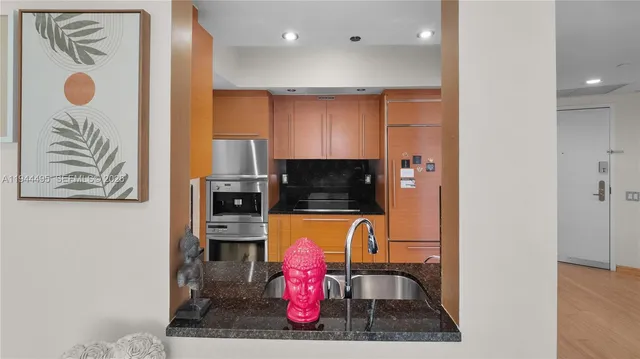 a kitchen with stainless steel appliances granite countertop a sink and cabinets