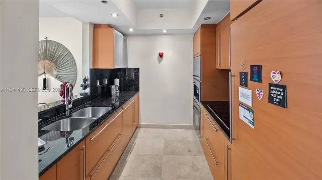 a kitchen with stainless steel appliances a refrigerator sink and stove