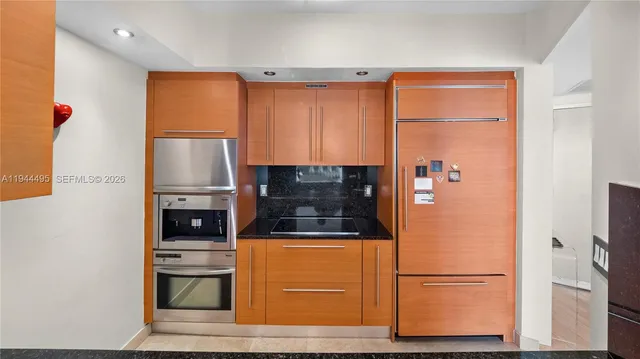 a bathroom with a granite countertop sink mirror and shower