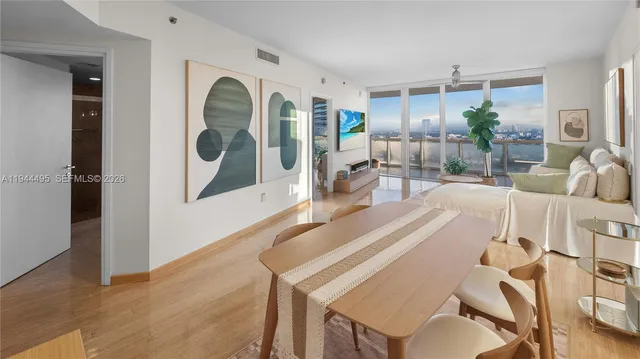 a view of a dining room with furniture and wooden floor