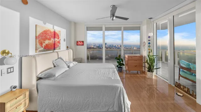 a bed room with a bed and a large window