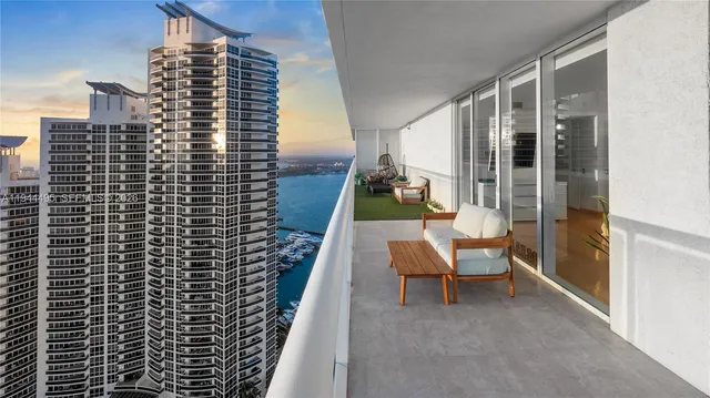 a view of balcony with a couple of chairs