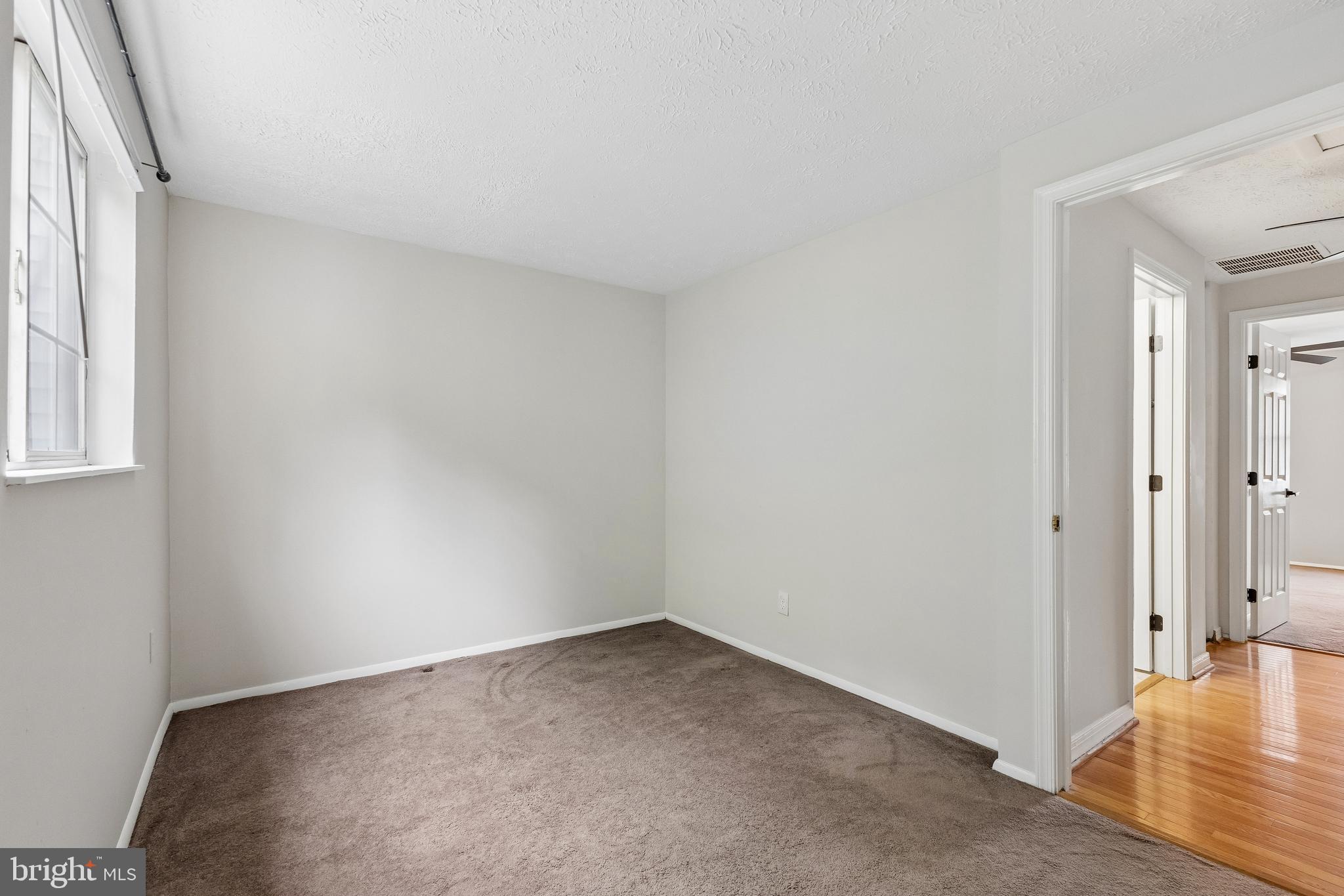 8317 Brookvale Court Springfield, VA 22153 - Photo 26 of 33 an empty room with wooden floor and windows