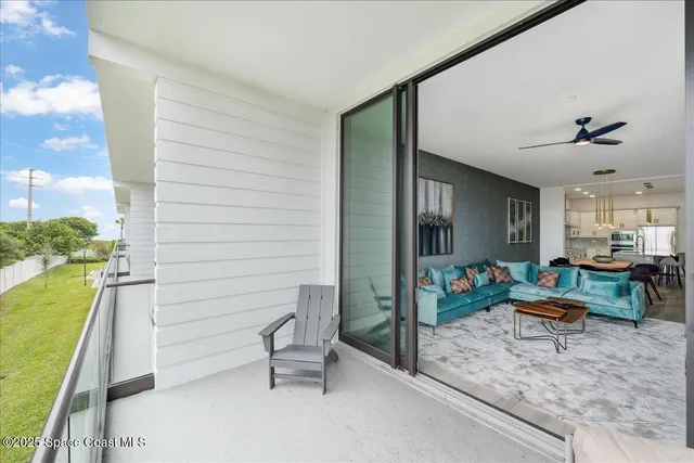 a view of roof deck with couches and potted plants